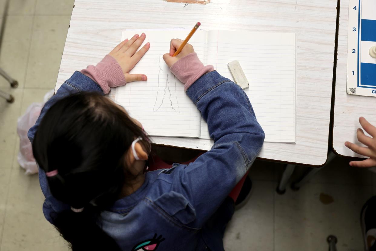 A student draws on a piece of paper during the second to last day of school as New York City public schools prepare to wrap up the year at Yung Wing School P.S. 124 on June 24, 2022 in New York City. 