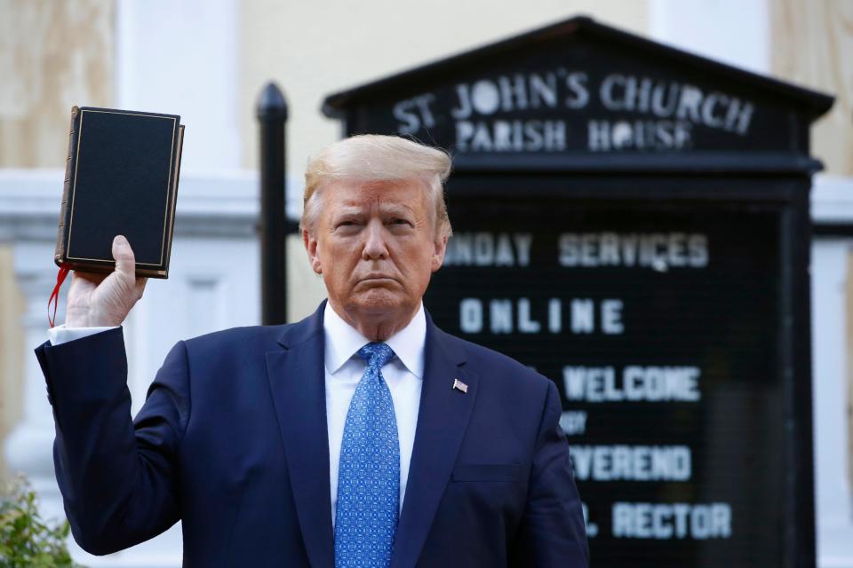 In this Monday, June 1, 2020 file photo, President Donald Trump holds a Bible as he visits outside St. John's Church across Lafayette Park from the White House.