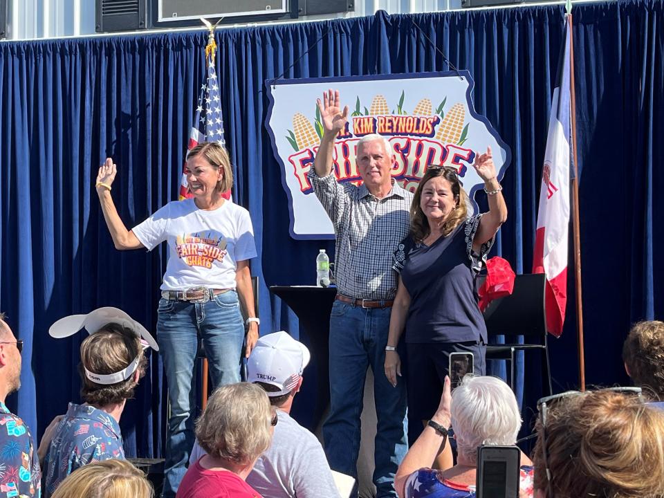 Former Vice President Mike Pence and his wife, Karen Pence, wave to the crowd after participating in Gov. Kim Reynolds' "Fair-Side Chat" on Friday, Aug. 11, 2023.