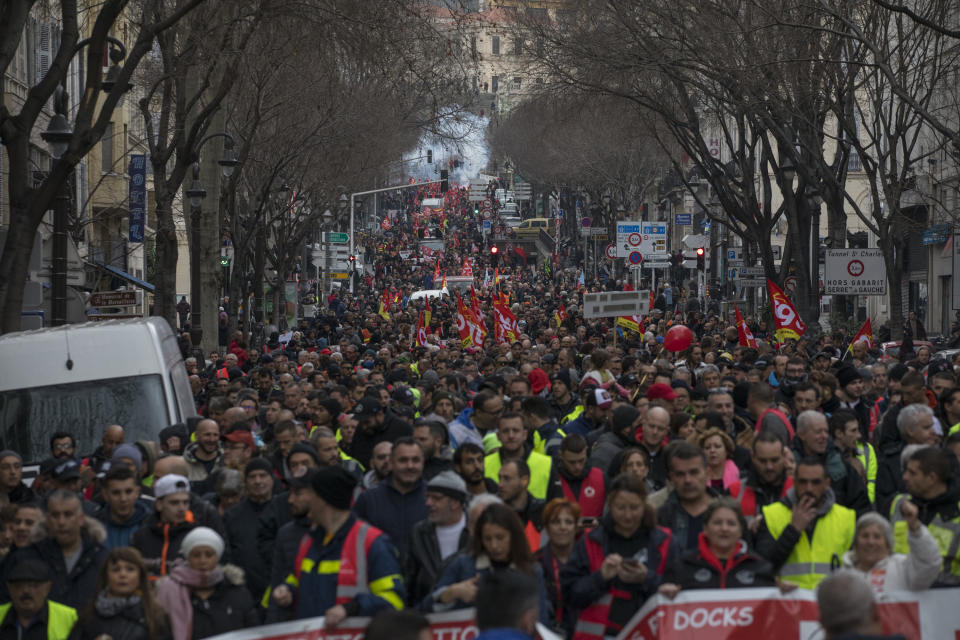 Protesters march during a demonstration in Marseille, southern France, Friday, Jan. 24, 2020. French unions are holding last-ditch strikes and protests around the country Friday as the government unveils a divisive bill redesigning the national retirement system. (AP Photo/Daniel Cole)