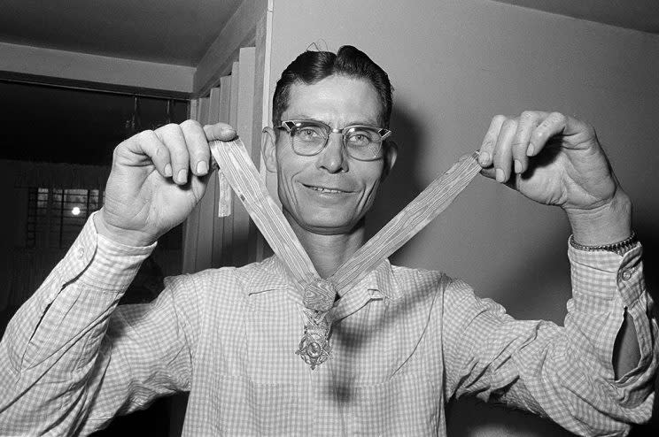 Desmond T. Doss, a Seventh Day Adventist and the only conscientious objector to win the Medal of Honor, displays his medal at his home in Rising Fawn, Ga., April 5, 1966. Doss won the medal as a medic on Okinawa in 1945. He says he would serve again if called upon. (AP Photo) 