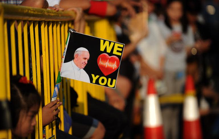 Well-wishers line the streets to catch a glimpse of Pope Francis in Manila on January 15, 2015