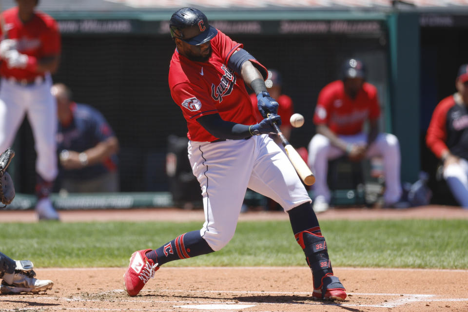 Cleveland Guardians designated hitter Franmil Reyes hits a one-run double against the Minnesota Twins during the first inning in the first baseball game of a doubleheader, Tuesday, June 28, 2022, in Cleveland. (AP Photo/Ron Schwane)