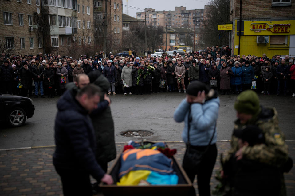 Bucha relatives gather to mourn the body of Oleksiy Zavadskyi, a Ukrainian serviceman who died in combat on Jan. 15 in Bakhmut, during his funeral in Bucha, Ukraine, Jan. 19, 2023.<span class="copyright">Daniel Cole—AP</span>