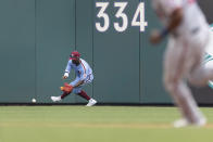 Philadelphia Phillies center fielder Andrew McCutchen (22) fields a double by Washington Nationals Josh Harrison, Josh Bell (19) runs to third during the sixth inning of a baseball game, Thursday, July 29, 2021, in Philadelphia in the first game of a double header. (AP Photo/Laurence Kesterson)