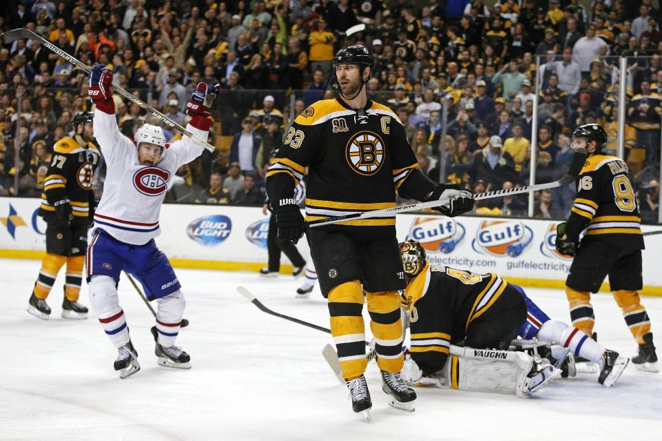 Montreal Canadiens right wing Brendan Gallagher, left, celebrates his teammate P.K. Subban's game-winning goal in the second overtime period as Boston Bruins defenseman Zdeno Chara (33) skates near in Game 1 of an NHL hockey second-round playoff series in Boston, Thursday, May 1, 2014. (AP Photo/Elise Amendola)