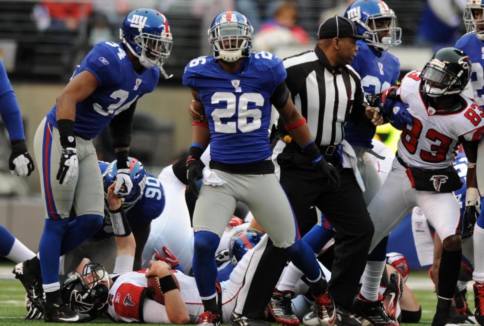 91181 Bergen; East Rutherford 1/8/2012  New York Giants safety Antrel Rolle (26) starts the celebration after stuffing Atlanta Falcons quarterback Matt Ryan (2) on a crucial 4th and 1 in the third quarter of Sunday's playoff win at MetLife Stadium. TYSON TRISH/STAFF PHOTOGRAPHER