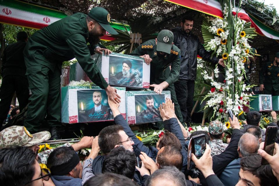 A picture of the late Iranian President Ebrahim Raisi is seen on his coffin during a funeral ceremony (via REUTERS)