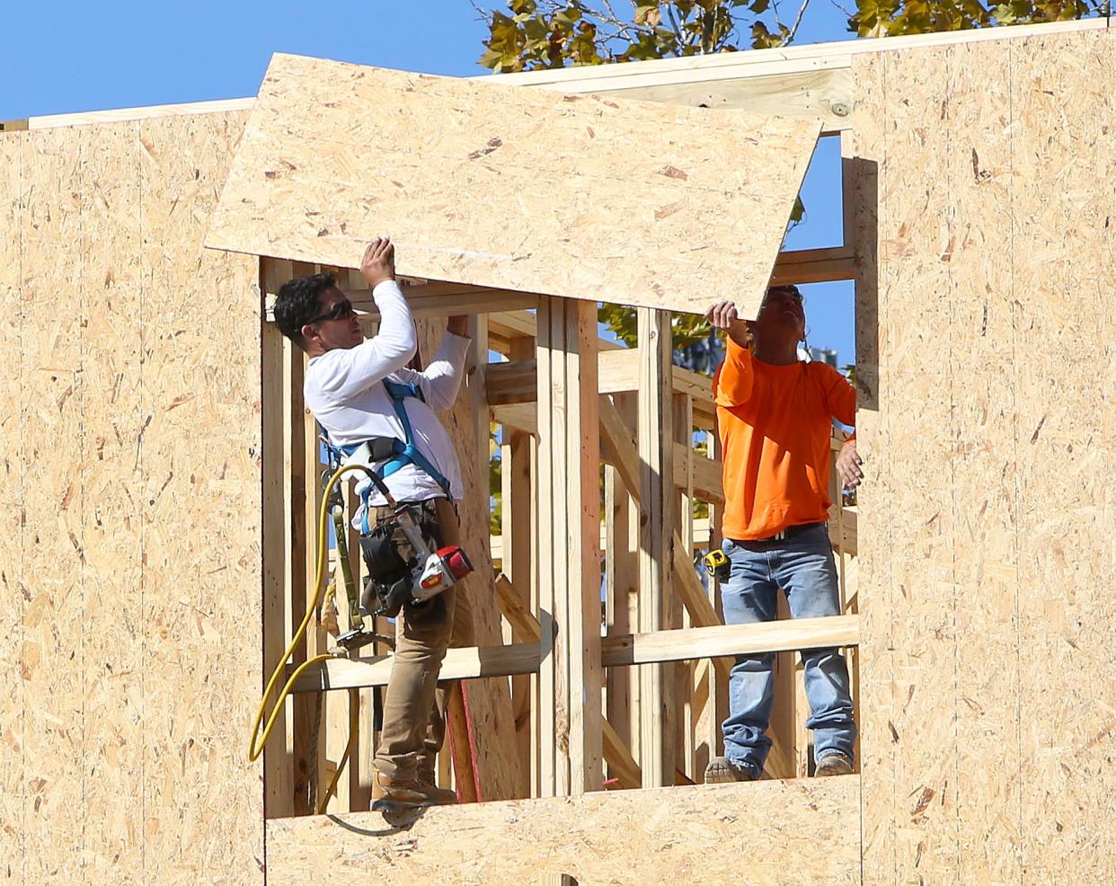 A construction crew works to build a new apartment complex off Southwest 13th Street in Gainesville in November 2020.