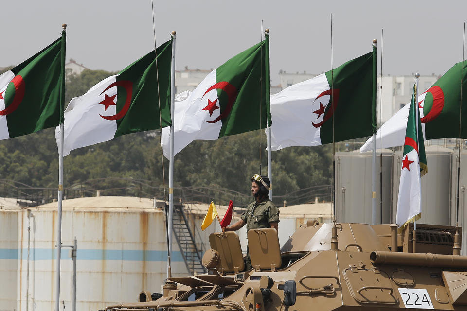 An Algerian soldier stands in a tank during a military parade to mark the 60th anniversary of Algeria's independence, Tuesday, July 5, 2022 in Algiers. Algeria is celebrating 60 years of independence from France with nationwide ceremonies, a pardon of 14,000 prisoners and its first military parade in years. (AP Photo/Toufik Doudou)