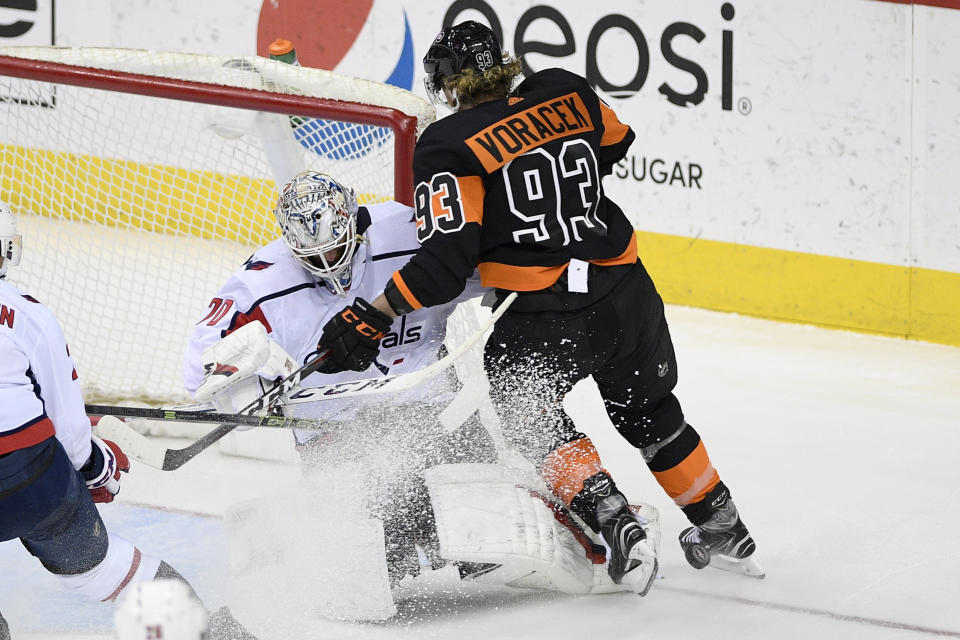 Washington Capitals goaltender Braden Holtby (70) stops Philadelphia Flyers right wing Jakub Voracek (93), of the Czech Republic, during the third period of an NHL hockey game, Sunday, March 24, 2019, in Washington. The Capitals won 3-1. (AP Photo/Nick Wass)