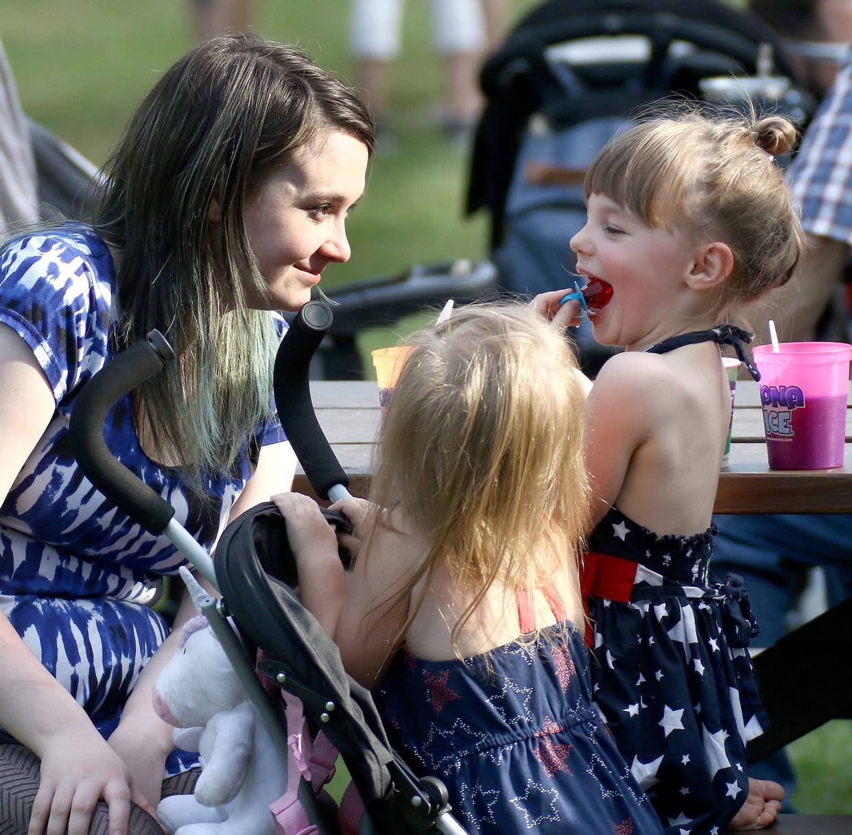 Cait Brushwood, left, her daughter Nora Berthiaume, right, and family friend Adalynn Anderson, front, enjoyed events on a warm July 4, 2022, evening at Silver Park.