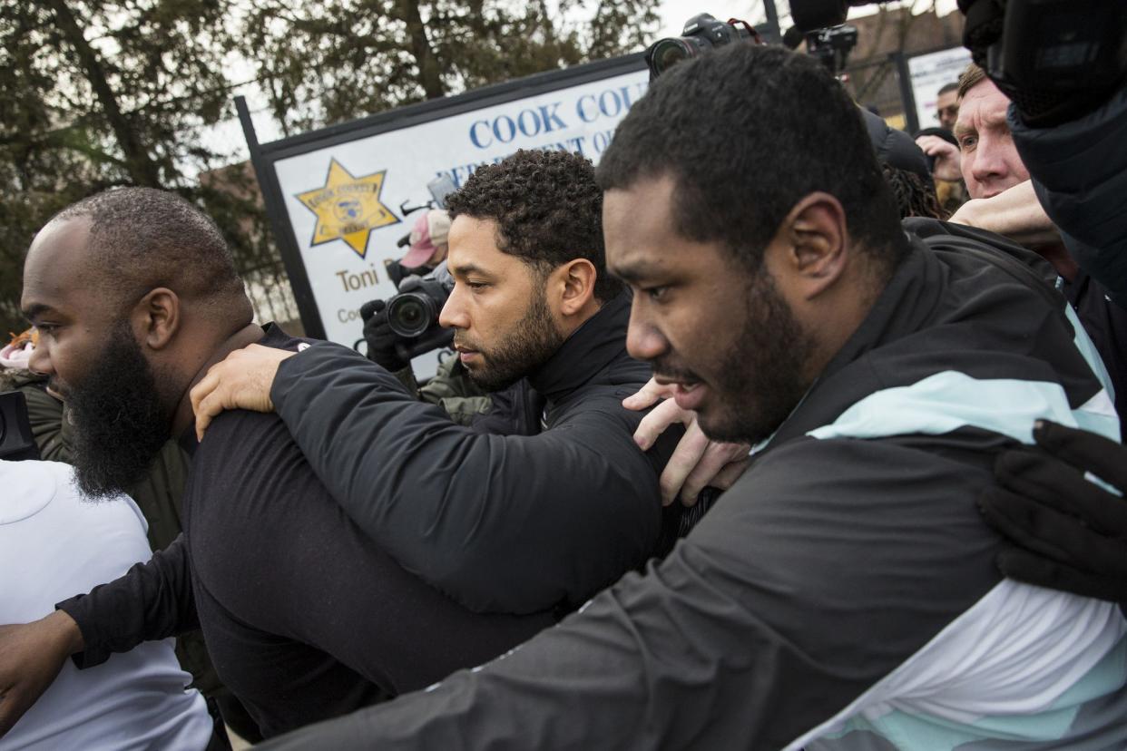 "Empire" actor Jussie Smollett, center, leaves Cook County jail following his release on Feb. 21, 2019, in Chicago, Ill. Smollett was charged with disorderly conduct and filling a false police report when he said he was attacked in downtown Chicago by two men who hurled racist and anti-gay slurs and looped a rope around his neck, a police official said.
