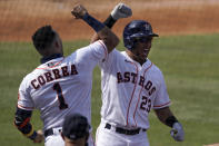 Houston Astros' Michael Brantley (23) celebrates with Carlos Correa after hitting a solo home run against the Oakland Athletics during the fifth inning of Game 4 of a baseball American League Division Series in Los Angeles, Thursday, Oct. 8, 2020. (AP Photo/Ashley Landis)