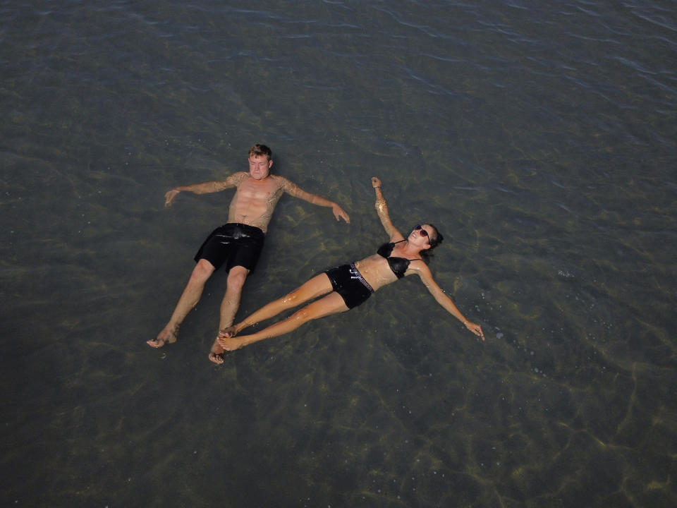 FILE - Benny and Faith Martens float on the water at the Great Salt Lake on Tuesday, Sept. 6, 2022, near Salt Lake City. About 27% of the water used in Utah comes from the Colorado River, with the majority of the state's water supply coming from other rivers that feed into the Great Salt Lake. (AP Photo/Rick Bowmer, File)