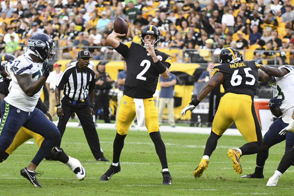 Pittsburgh Steelers quarterback Mason Rudolph (2) throws a touchdown pass as Seattle Seahawks defensive tackle Quinton Jefferson (77) pressures during the first half of an NFL preseason football game Saturday, Aug. 13, 2022, in Pittsburgh. (AP Photo/Fred Vuich)