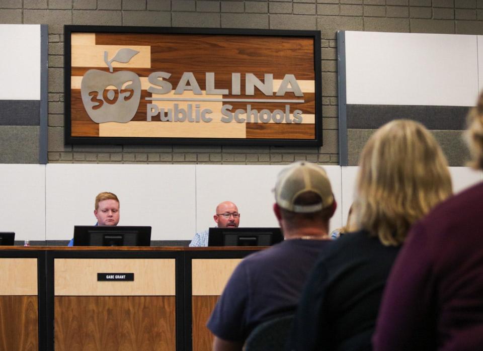 Salina community members listen to a proposal at a USD 305 Board of Education meeting in September. There are five candidates running for four at-large seats on the board this November.