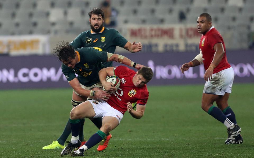 Owen Farrell of the British & Irish Lions is tackled by Franco Mostert of South Africa during the 2nd Test between South Africa - Getty Images