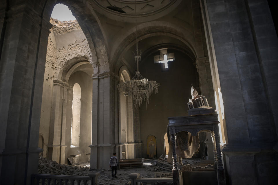 A man walks inside the damaged Ghazanchetsots (Holy Saviour) Cathedral in the historic city of Shusha, October 2020.<span class="copyright">Aris Messinis—AFP/Getty Images</span>