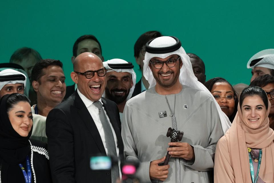 United Nations Climate Chief Simon Stiell, from left, COP28 President Sultan al-Jaber and Hana Al-Hashimi, chief COP28 negotiator for the United Arab Emirates, pose at the end of the COP28 U.N. Climate Summit, Wednesday, Dec. 13, 2023, in Dubai, United Arab Emirates. (AP Photo/Kamran Jebreili)