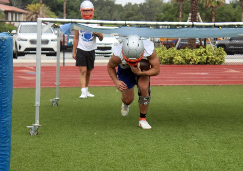 Bolles running back Emmett Grzebin runs through drills at high school football practice on July 31.