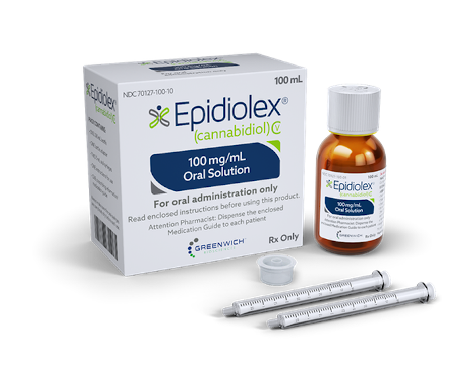 A vial of Epidiolex next to its packaging box and two droppers.