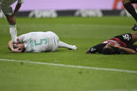 Bremen's Amos Pieper, left, and Frankfurt's Tuta lie on the ground after a collision during the Bundesliga soccer match between Eintracht Frankfurt and Werder Bremen at the Deutsche Bank Park stadium in Frankfurt, Germany, Friday April 5, 2024. (Arne Dedert/dpa via AP)