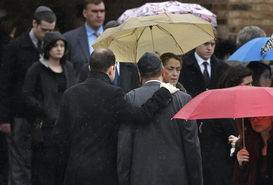 Mourners support one another as they depart funeral services for 17-year-old Sam Berns at Temple Israel, Tuesday, Jan. 14, 2014, in Sharon, Mass. Berns died Friday after complications from Hutchinson-Gilford progeria syndrome, commonly known as progeria, a rare genetic condition that accelerates the aging process. (AP Photo/Steven Senne)