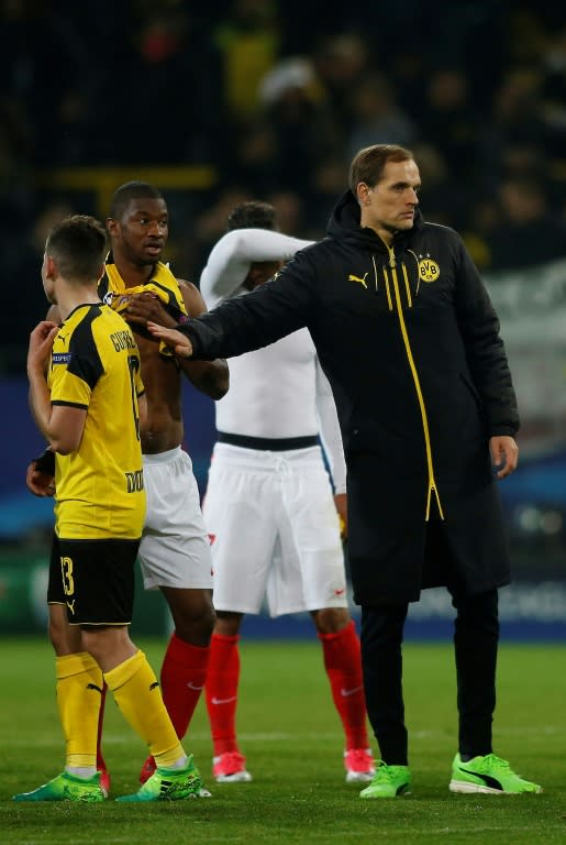 Dortmund's head coach Thomas Tuchel (R) and players react after losing their UEFA Champions League quarter-final 1st leg match against Monaco, in Dortmund, on April 12, 2017