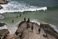 People enjoy the Ipanema beach amid the new coronavirus pandemic in Rio de Janeiro, Brazil, Sunday, Sept.6, 2020. Brazilians are packing the beaches and bars this weekend, taking advantage of a long holiday to indulge in normal life even as the COVID-19 pandemic rages on. (AP Photo/Bruna Prado)