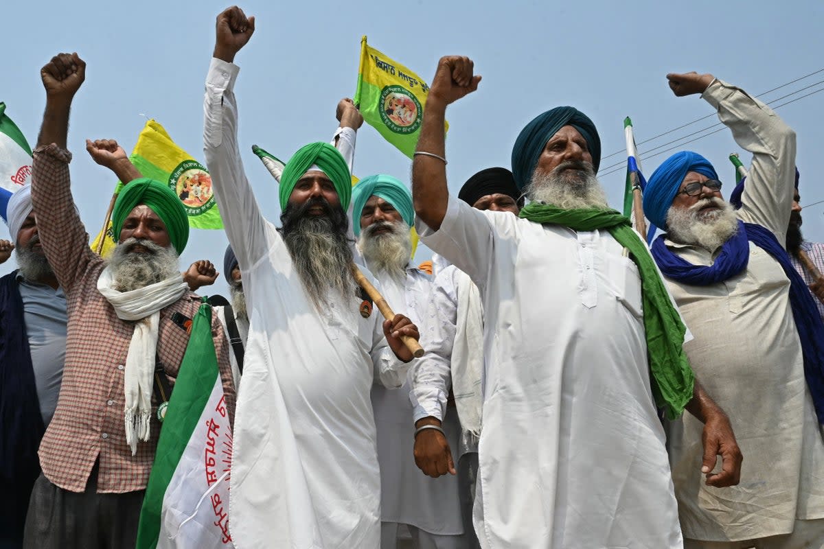 Farmers shout slogans against India’s Prime Minister and leader of the ruling Bharatiya Janata Party (BJP) Narendra Modi, during a protest to demand minimum crop prices on the outskirts of Gurdaspur (AFP via Getty Images)