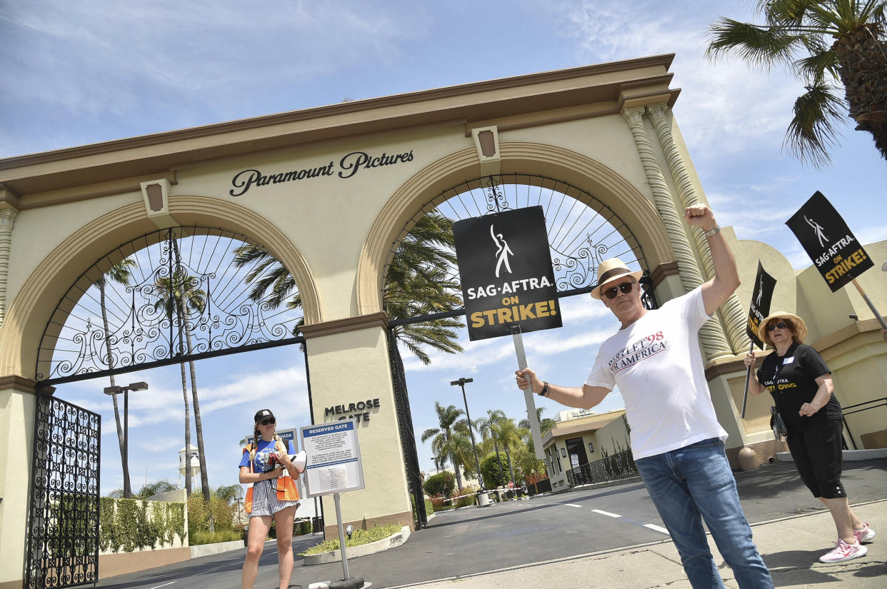 Picketers carry signs outside Paramount studios on Friday, July 21, 2023, in Los Angeles. 