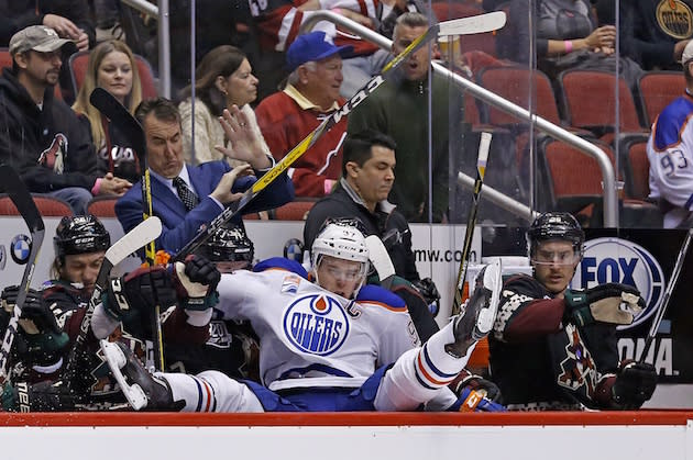 Edmonton Oilers center Connor McDavid ends up over the boards and into the Arizona Coyotes bench during the second period of an NHL hockey game Friday, Nov. 25, 2016, in Glendale, Ariz. (AP Photo/Ross D. Franklin)