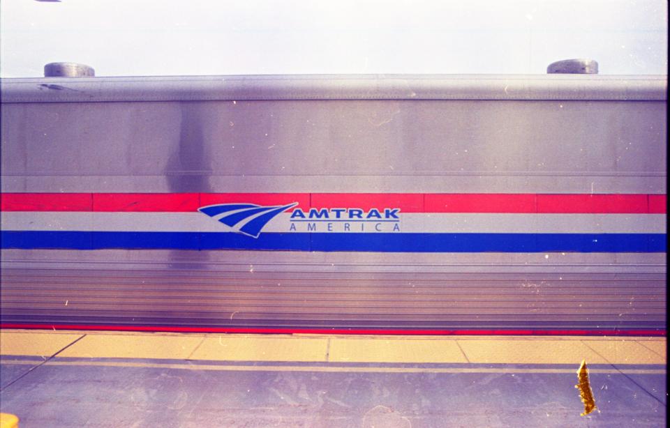 Amtrak exterior with red and blue stripes and silver metal