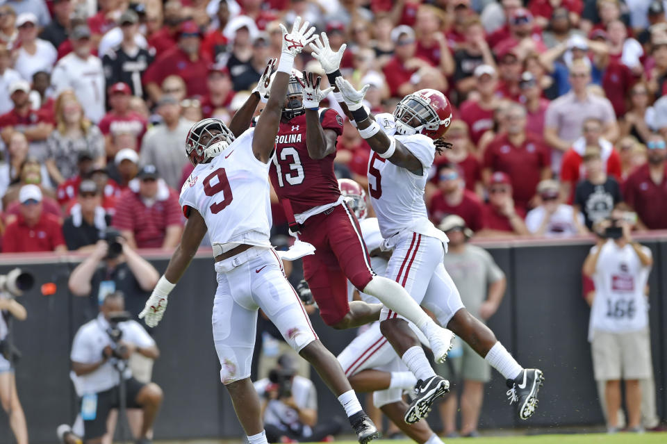 South Carolina's Shi Smith, center, goes up for a touchdown pass while defended by Alabama's Jordan Battle, left, and Shyheim Carter during the first half of an NCAA college football game Saturday, Sept. 14, 2019, in Columbia, S.C. (AP Photo/Richard Shiro)