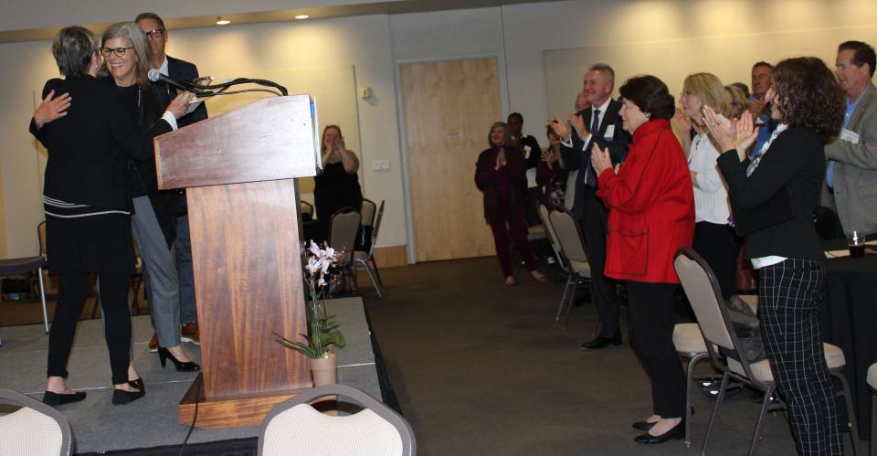 Kate McLean, left, founder of the Center for Nonprofit Leadership, and Jane Goodall hug as Steve Goodall watches. Jane and Steve Goodall were honored Tuesday in Ventura for their efforts in the nonprofit sector.