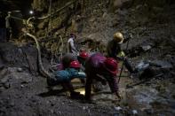 Miners work inside a ruby mine in Mogok, Myanmar