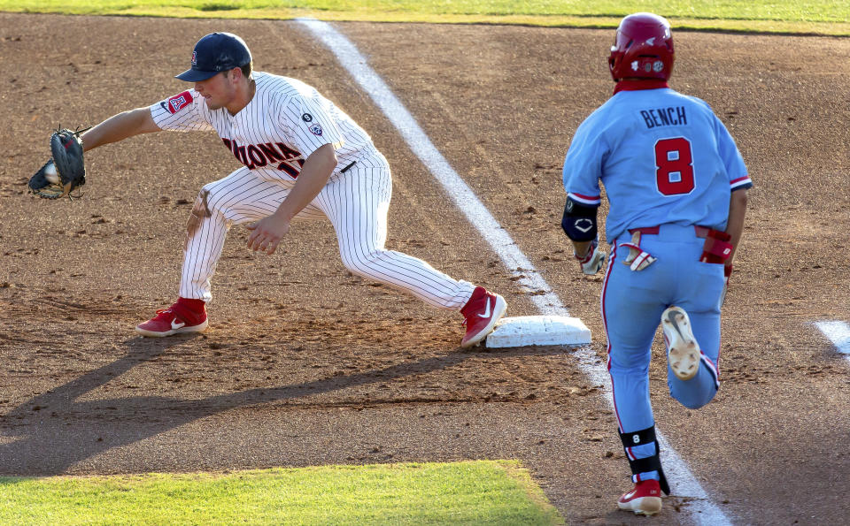 Arizona first baseman Branden Boissiere, left, gets Mississippi's Justin Bench (8) out at first base during an NCAA college baseball super regional game Sunday, June 13, 2021, in Tucson, Ariz. (Rebecca Sasnett/Arizona Daily Star via AP)