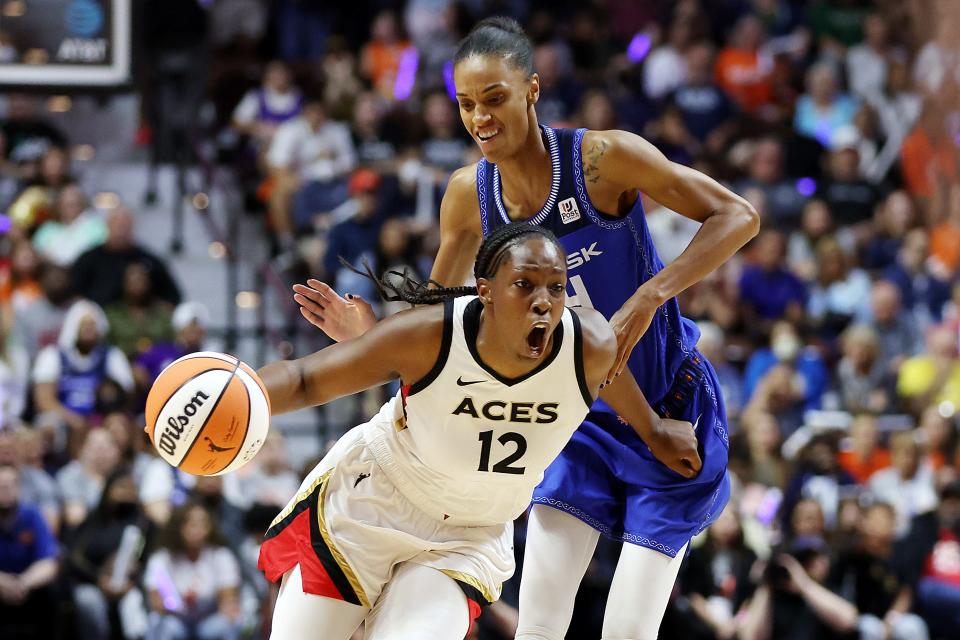 Las Vegas Aces guard Chelsea Gray dribbles against Connecticut Sun forward DeWanna Bonner during Game 4 of the WNBA Finals.