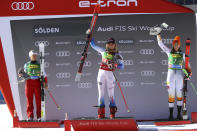 FILE - United States' Mikaela Shiffrin, center, celebrates with second-place Switzerland's Lara Gut-Behrami, left, and third-place Slovakia's Petra Vlhova on the podium after a women's World Cup giant slalom ski race in Soelden, Austria, Oct. 23, 2021. Shiffrin is expected to enter all five individual Alpine events and be one of the main faces of the Olympics that officially open on Feb. 4. (AP Photo/Marco Trovati, File)