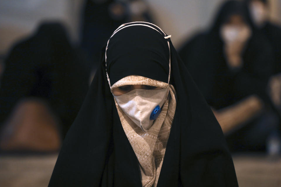 A worshipper wearing a protective face mask to help prevent the spread of the coronavirus prays at the mosque of the Tehran University on Laylat al-Qadr, or the night of destiny, during holy fasting month of Ramadan, in Tehran, Iran, Tuesday, May 12, 2020. On Tuesday authorities allowed mosques to temporarily reopen for limited hours up to two hours strictly observing health and social procedures to prevent spreading the disease, in the predominantly Shiite country for three continuous nights from Tuesday which people believe the Laylat al-Qadr night happens either on 19th, 21st or 23rd of the holy month of Ramadan. Laylat al-Qadr is the night when Muslims believe the Quran was first revealed to prophet Muhammad. (AP Photo/Vahid Salemi)