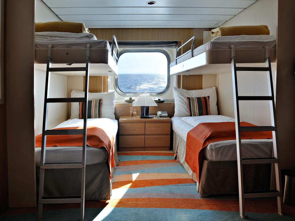 A cruise-ship cabin with bunk beds.