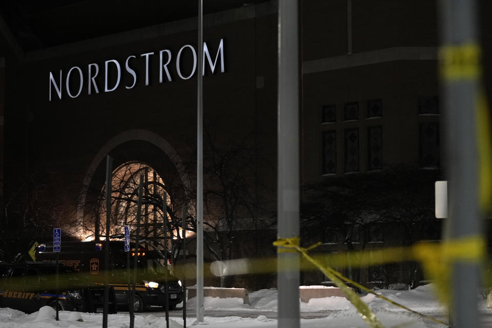 Caution tape and police cars are seen outside Nordstrom at Mall of America after a shooting, Friday, Dec. 23, 2022, in Bloomington, Minn. (AP Photo/Abbie Parr)