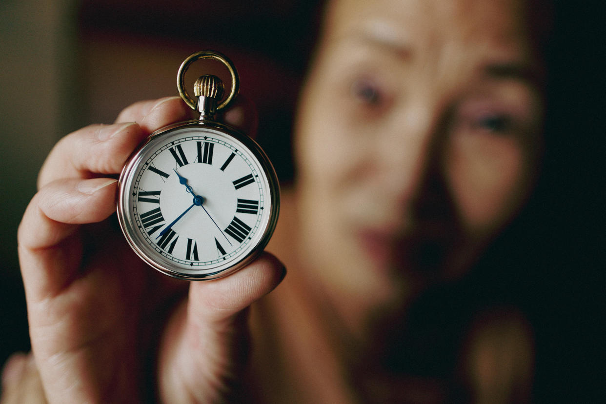 A person holding a pocket watch