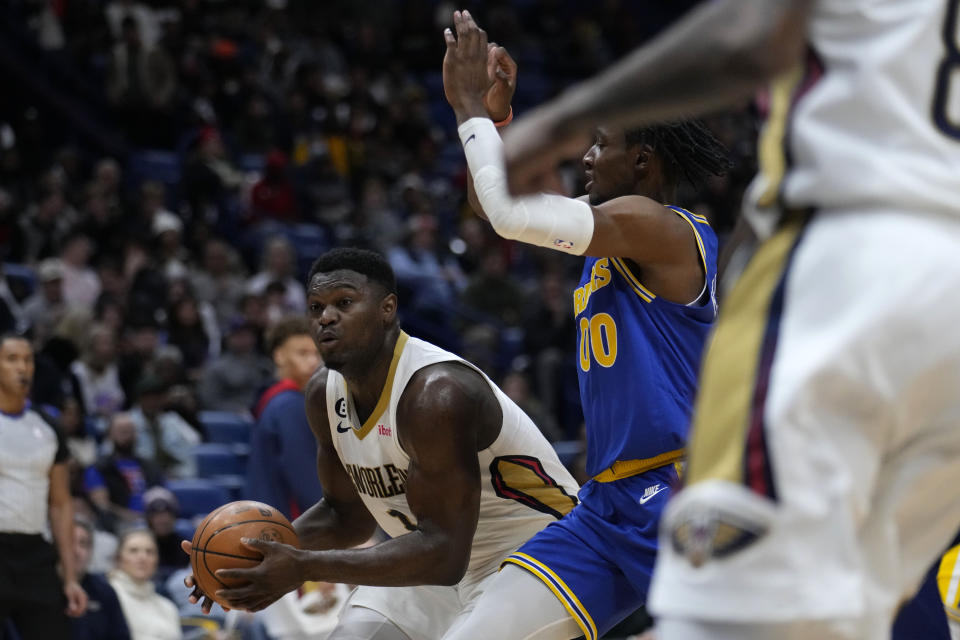 New Orleans Pelicans forward Zion Williamson (1) moves to the basket against Golden State Warriors forward Jonathan Kuminga (00) in the first half of an NBA basketball game in New Orleans, Monday, Nov. 21, 2022. (AP Photo/Gerald Herbert)