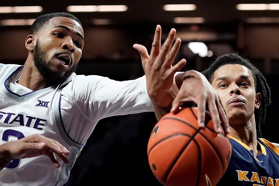 Kansas State forward David N'Guessan, left, and Kansas City guard Tyler Andrews battle for a loose ball during their game Thursday at Bramlage Coliseum.