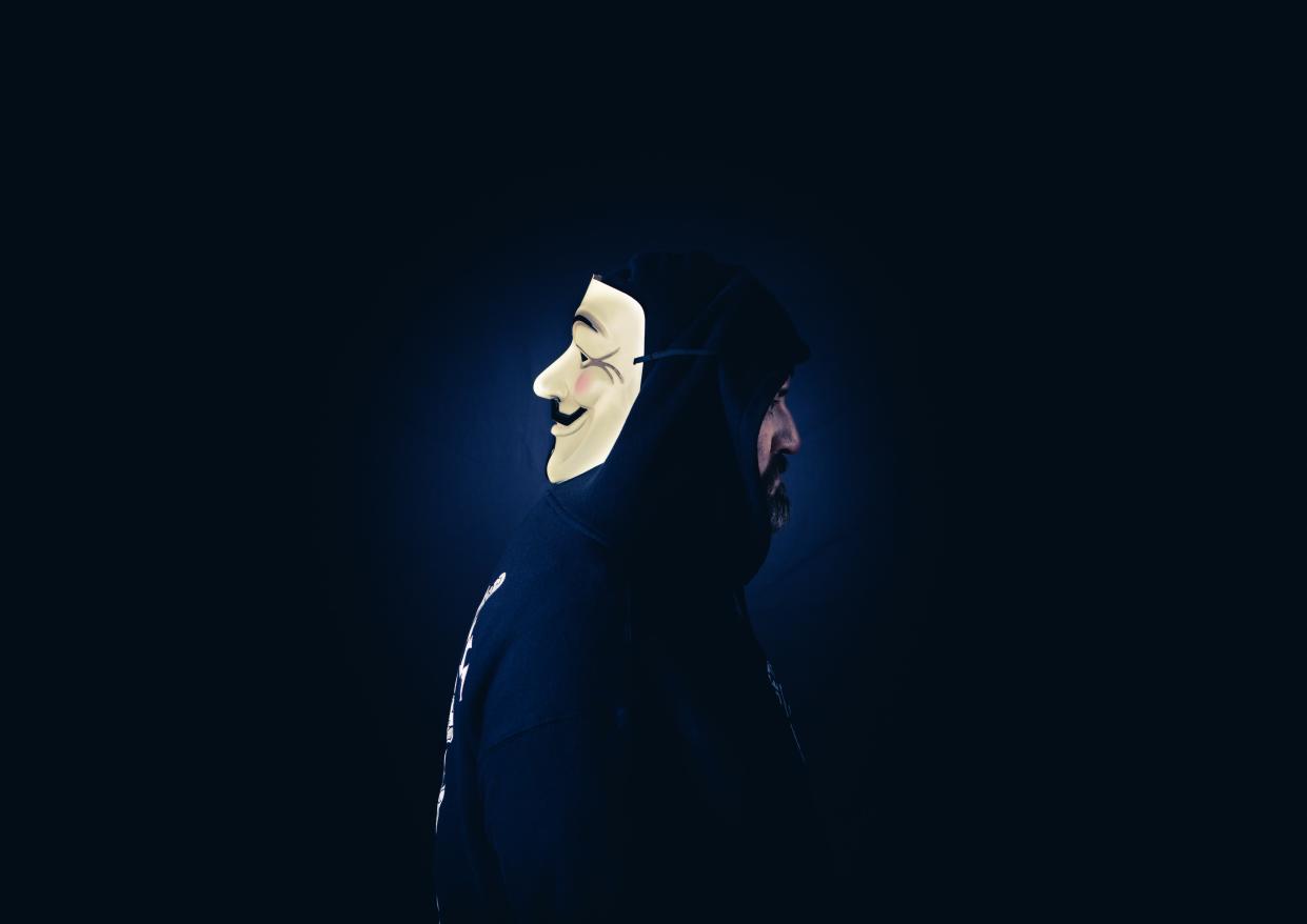 A person with a hacker mask. 
