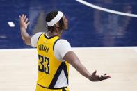 Indiana Pacers' Myles Turner reacts after hitting a 3-point shot during the second half of Game 4 of the first round NBA playoff basketball series against the Milwaukee Bucks, Sunday, April 28, 2024, in Indianapolis. (AP Photo/Michael Conroy)