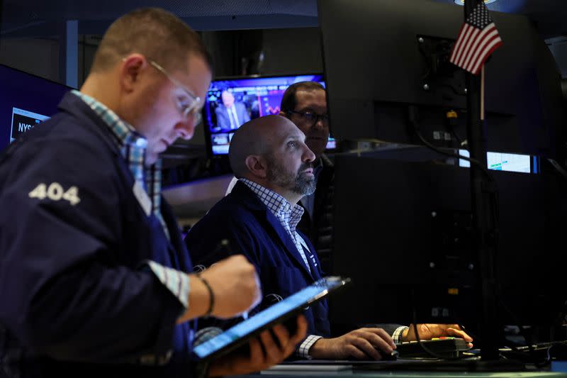 Traders work on the floor of the NYSE in New York