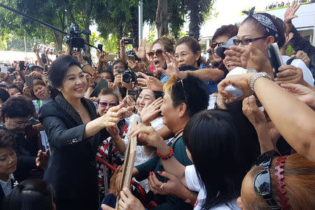 Ousted former Thai prime minister Yingluck Shinawatra greets supporters as she leaves the Supreme Court in Bangkok, Thailand, August 1, 2017. REUTERS/Aukkarapon Niyomyat